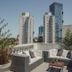 After Hotel Montevideo rooftop terrace with lounge seating and Montevideo skyline views