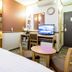 Toyoko Inn Yamagata-eki Nishi-guchi room with bed, desk, TV, chairs and round table in Yamagata