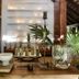 Kimpton Aluna Tulum lounge with wooden table, candles, plants and slatted wall decor in Tulum