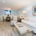 Crane's Beach House Boutique Hotel & Luxury Villas in Delray Beach living area with white sofa and dining table