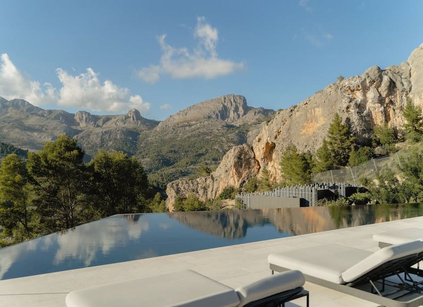 Vivood Landscape Hotel in Benimantell: infinity pool with mountain views and rocky cliffs
