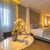 Hotel Cercano Gramado guest room with canopy bed, marble table, and warm ambient lighting