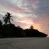 Blue World Dharavandhoo beach at sunset with palm trees and calm ocean view in Dharavandhoo