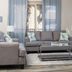 Shores of Panama Resort living room with gray sofa, armchair, coffee table and balcony doors in Panama City Beach