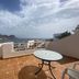 Aparthotel Vistamar in San José terrace with table and chairs overlooking the sea and mountains