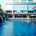 Centara Pattaya Hotel in Pattaya with outdoor pool, rock feature, and poolside umbrellas