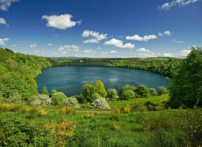 Landhotel Krolik in Daun with scenic lake view, green hills and blue sky