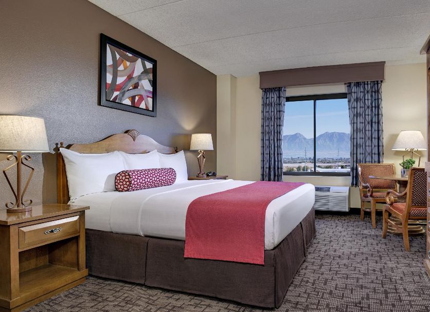 Fiesta Rancho Hotel And Casino Las Vegas guest room with king bed and mountain view through window