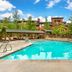 Hilton Grand Vacations Club Sunrise Lodge Park City outdoor pool with mountain resort buildings