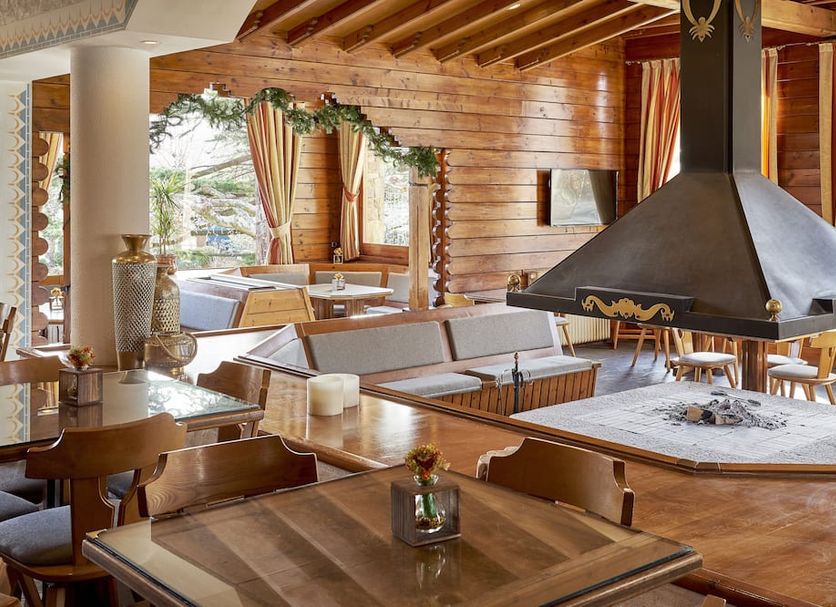 Hotel Grèvol Spa in Llanars, rustic lounge with fireplace, wooden beams, and seating area