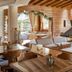 Hotel Grèvol Spa in Llanars, rustic lounge with fireplace, wooden beams, and seating area