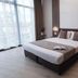 B1 Boutique Hotel Sofia in Sofia: modern room with king bed, floor-to-ceiling windows and bedside lamps