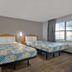 Studio 6 Ft Worth - North Richland Hills room with two beds, desk, and window view