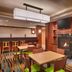 Fairfield Inn & Suites by Marriott Boise Nampa lobby lounge with fireplace, tables, bar stools and TV in Nampa