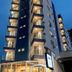 Lym Flat Hotel in Uberlândia exterior with illuminated balconies at dusk