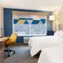 Holiday Inn Express & Suites Drums-Hazleton guest room with two beds, desk, and snowy window view