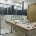 Hotel Santiago, Praia bathroom with glass shower, double sink vanity and toilet