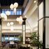 Hilton Garden Inn Auburn Lewiston Riverwatch lobby with hanging globe lights and seating area