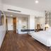Shota@Rustaveli Boutique hotel Tbilisi room with king bed, modern seating area and wall art