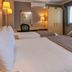 Best Western Heath Court Hotel in Newmarket room with two beds, desk, window, and armchair