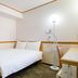 Toyoko Inn Kofu eki Minami guchi No 2 room with bed, desk and floor lamp in Kōfu