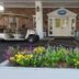 Riverboat Inn and Suites Madison entrance with flower bed and golf carts under a covered entry
