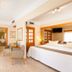 Gf Fañabe Adeje guest room with bed, TV, sitting area and tiled floor