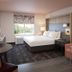 Holiday Inn St. Louis - Creve Coeur By IHG guest room with king bed, window view, and seating area