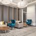 Crowne Plaza San Antonio Airport lobby seating area with sofas, blue chairs, and coffee tables