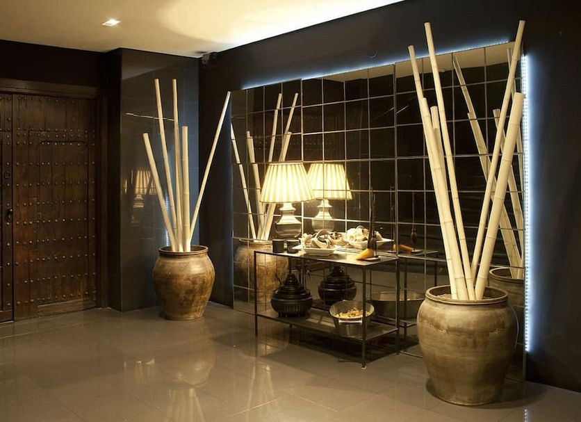 Hotel Ruta de Europa in Vitoria-Gasteiz lobby with decorative vases, lamps and tiled wall