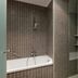 AC Hotels by Marriott Bologna bathroom with tiled walk-in shower and bathtub