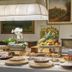 Valle Del Buttero in Capalbio breakfast buffet with pastries, fruit, and flowers on a table
