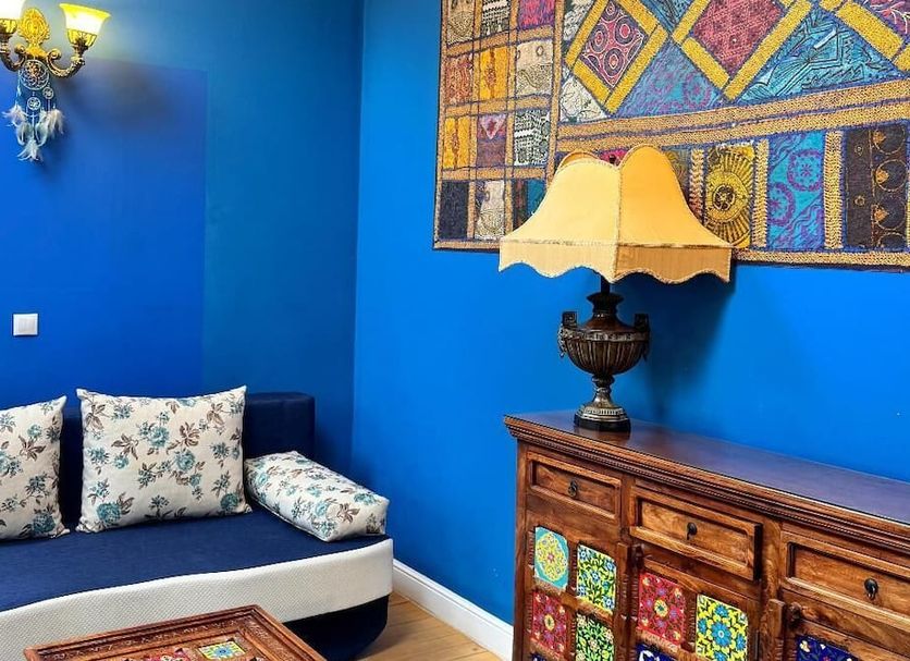 Hotel Regal 1880 in Sinaia, blue lounge with patterned sofa, lamp and colorful wall art