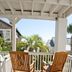 Desoto Beach Terraces in Tybee Island balcony with two wooden rocking chairs and palm view