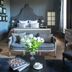 La Divine Comédie-Suites Deluxe in Avignon, elegant suite with king bed, sofa, black chairs and floral centerpiece