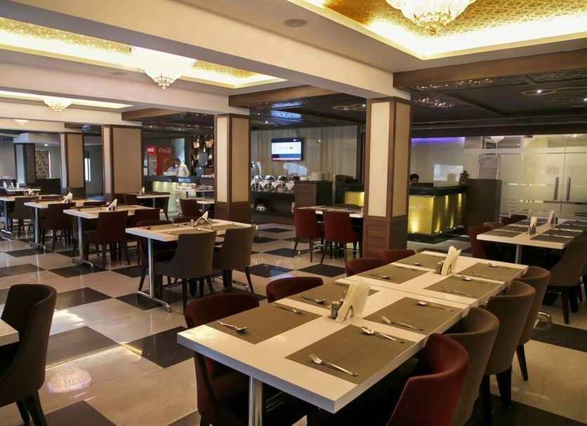 Hotel Ganges Grand Varanasi restaurant dining area with tables and chairs