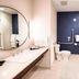 Fairfield Inn & Suites by Marriott Ottawa Airport bathroom with vanity, toilet, tub-shower, and navy accent wall