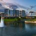 AC Hotels by Marriott Tallahassee Universities at the Capitol overlooking a lake with fountain at dusk