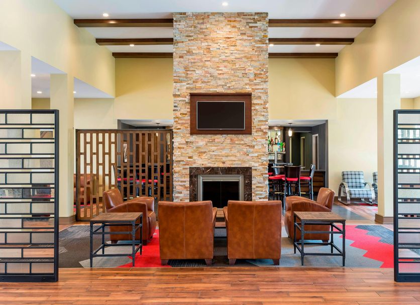 Four Points by Sheraton Buffalo Grove lobby with stone fireplace, seating area, and lounge chairs