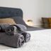 Les Suites de Bellac in Bellac: neatly rolled gray towels on a bed in a guest room