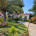 Bare Hill Holiday Apartments in Kyrenia with landscaped garden, palm trees, and paved walkway