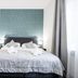 7Days B&B in Bratislava bedroom with wall-mounted TV, teal accent wall, and neatly made bed