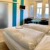 Gästehaus Seewarte in Flensburg room with twin beds, seating area, and city-view windows