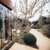 Ristolocanda Grani di Pepe in Flaibano with glass-walled dining area beside a garden path