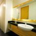 Citihub Hotel @Pecindilan Surabaya bathroom with sink, mirror, and walk-in shower