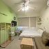 Rhine Castle Hotel in Taichung City guest room with bed, sofa, desk, TV, and ceiling fan