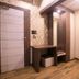 Hotel Welcome Palace, Agartala: hotel room entryway with desk, mirror, wardrobe and bench