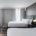 The Warrior Hotel, Autograph Collection in Sioux City guest room with two beds and tall windows