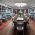 Graduate by Hilton State College library lounge with long table, bookshelves and chandelier