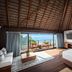 Secrets Tulum Resort And Beach Club suite with ocean view, balcony seating and wooden vaulted ceiling in Tulum